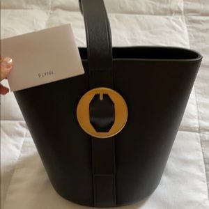 Designer, Flynn. Black and gold buckle bag